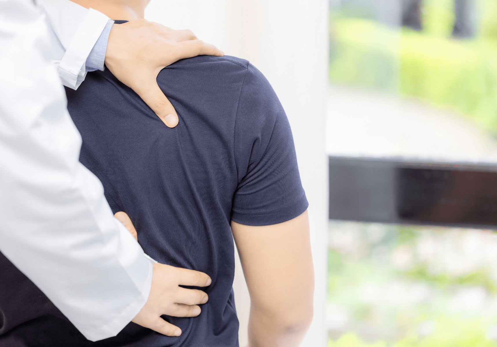 edmonton in home chiropractor assessing shoulder